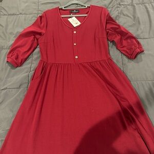 Brand new red dress with tags, knee length and 3/4 length sleeves.